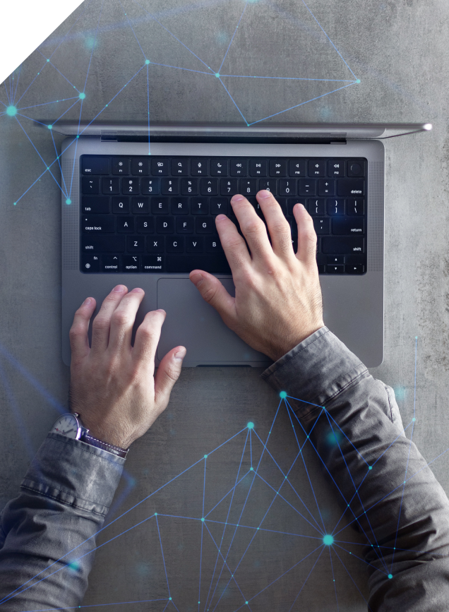 Hands typing on a laptop overlaid with a network visualisation